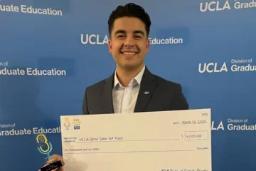 MIMG Graduate Student Pablo Alvarez smiling and holding 1st place winner check. 