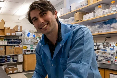 James Brown smiling with lab in the background.