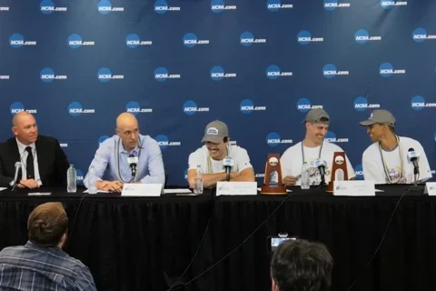 Panel of head coach and players being interviewed 