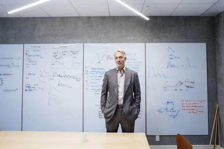 Alexander Hoffman standing in front of whiteboard