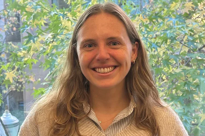 Nicole Wilkinson smiling with tree in the background.
