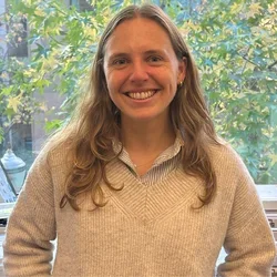 Nicole Wilkinson smiling with tree in the background.