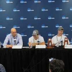 Panel of head coach and players being interviewed 
