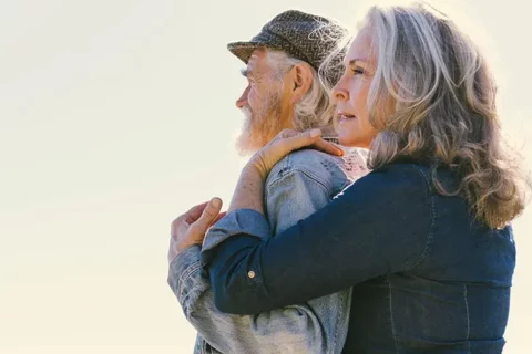 Women embracing a man
